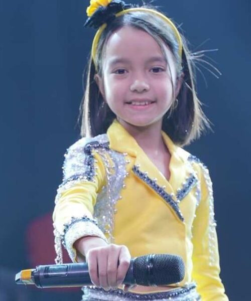 Sa Re Ga Ma Pa Li’l Champs Jetshen Dohna Lama, age 9, is the Winner and raises the trophy.